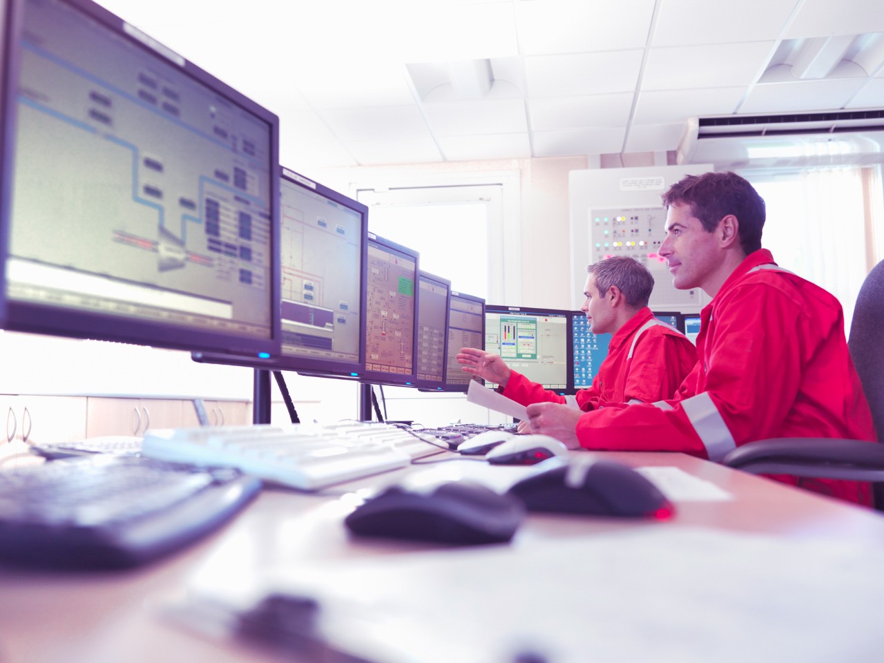 Workers in control room of gas plant --- Image by © Monty Rakusen/cultura/Corbis